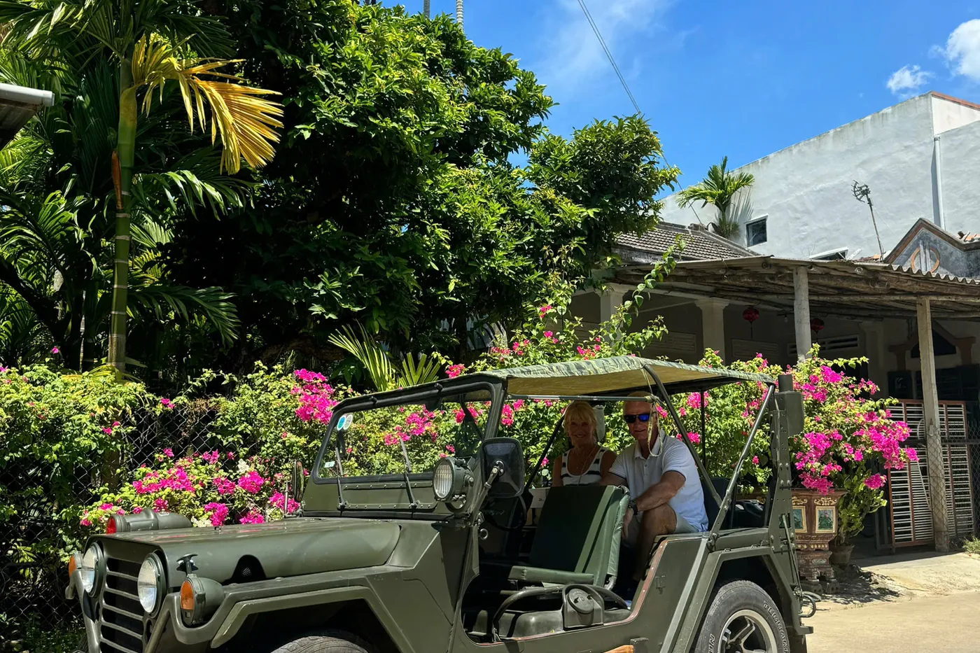 Couple in Jeep with bougainvillea Hoi An island tour DDTravel
