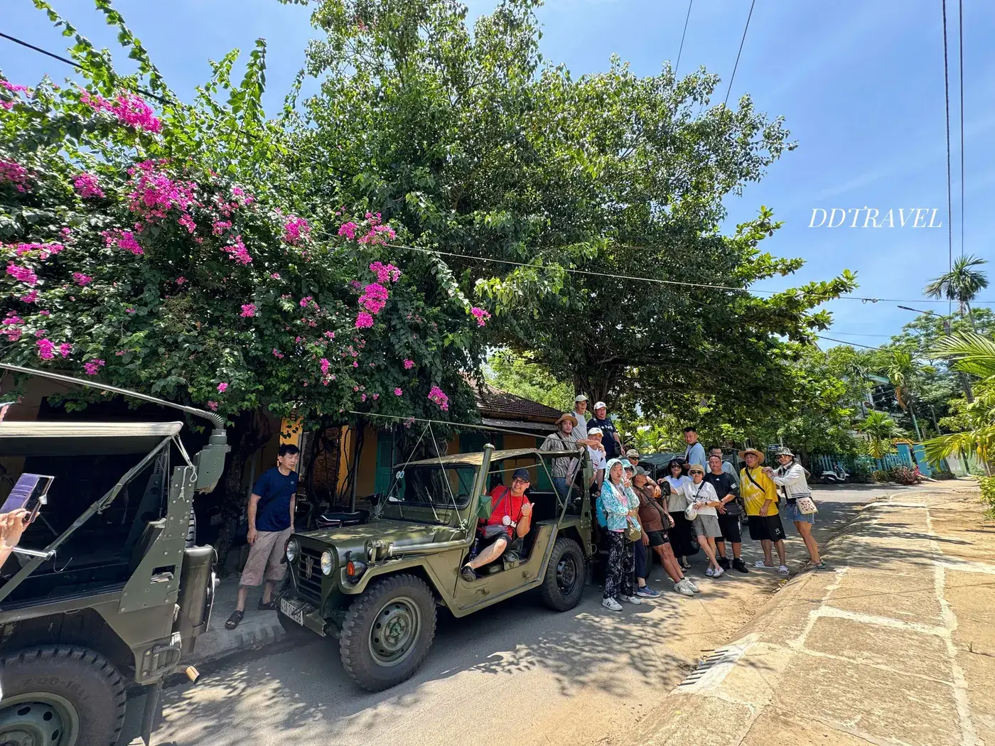 Group with Jeep bougainvillea village Hoi An island tour DDTravel