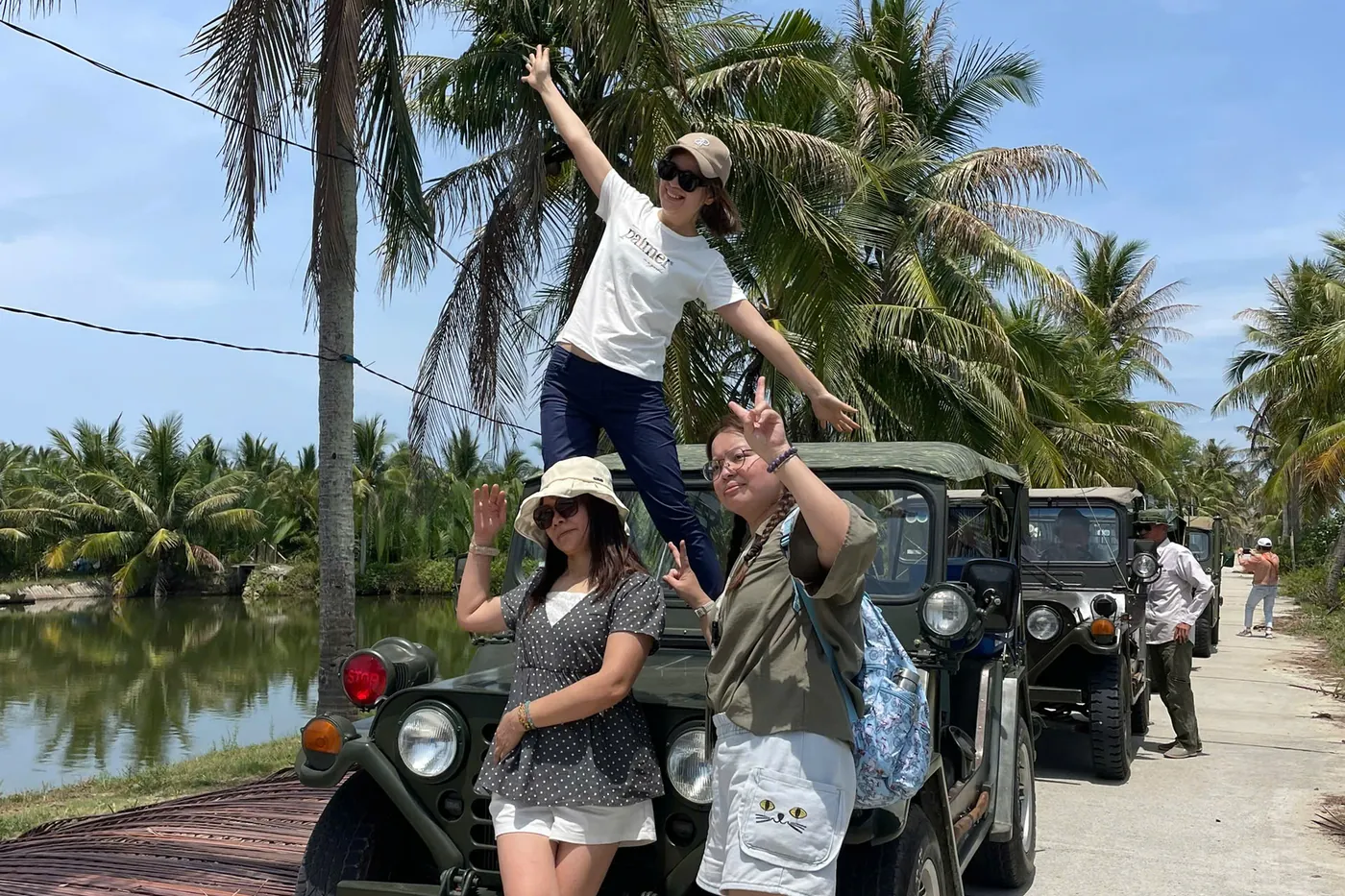 Ladies posing Jeep palm road Hoi An island tour DDTravel