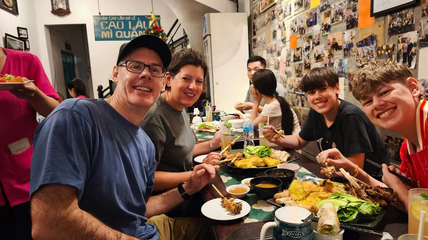 Family enjoying Cao Lau river restaurant Hoi An street food tour DDTravel