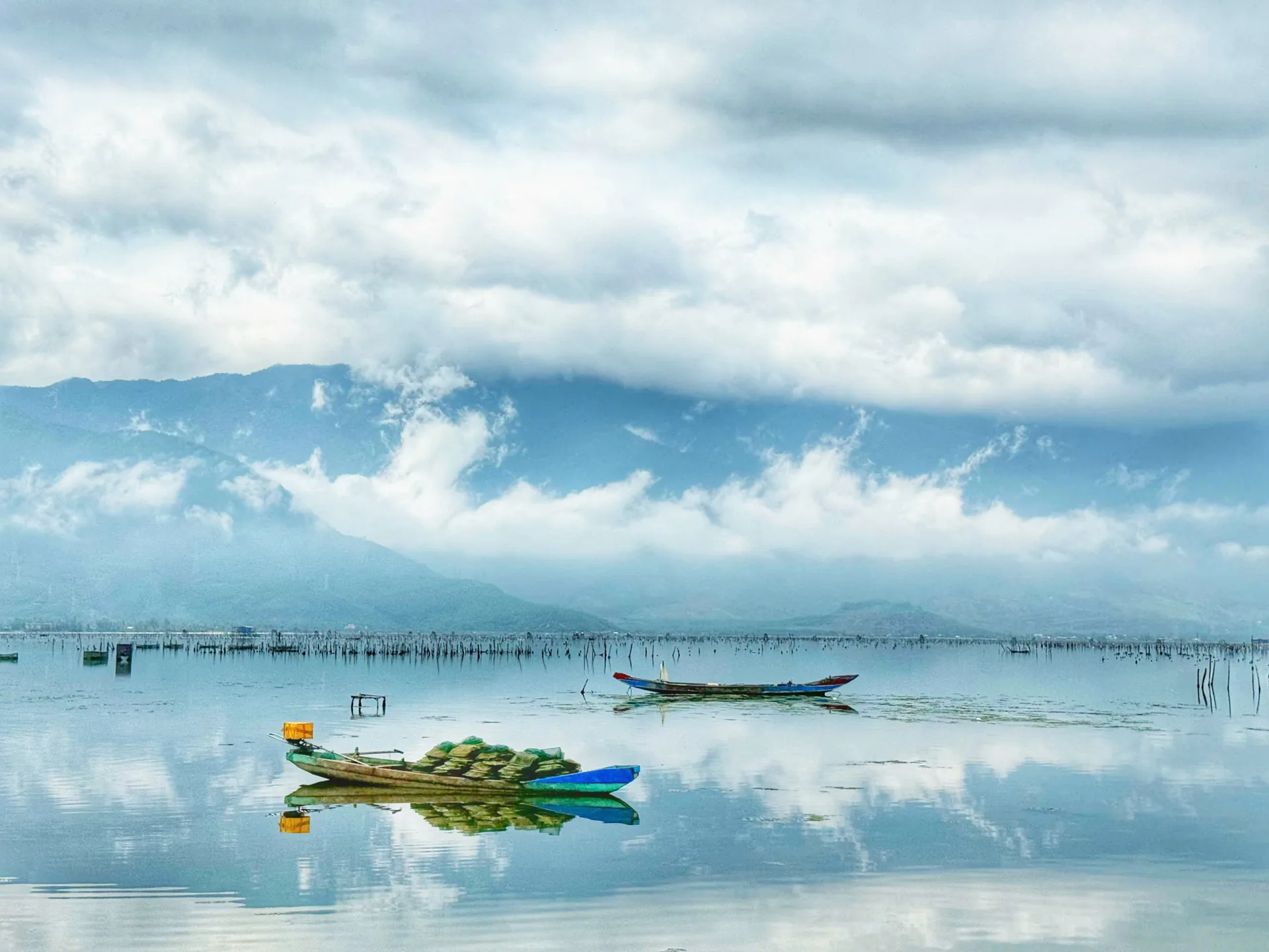 Lap An Lagoon fishing boats mirror reflection Hai Van Pass Vespa tour